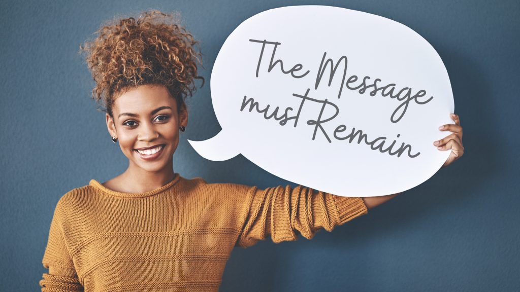 woman holding sign message must remain