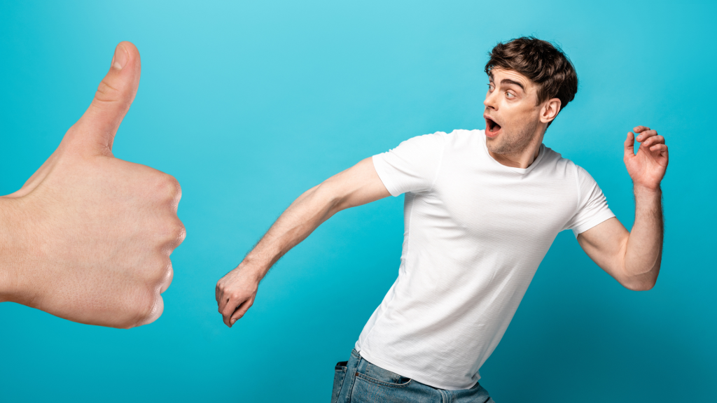 man running from large thumb