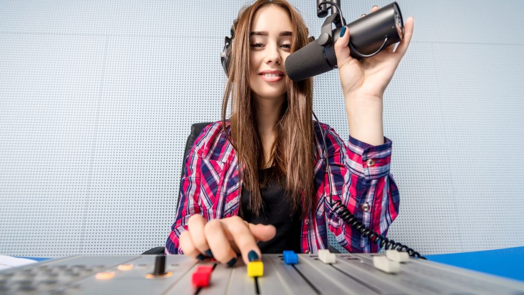 woman talking on mic with soundboard