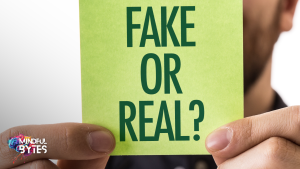 man holding post note that says fake or real