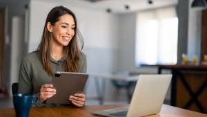 woman taking notes during webinar on tablet